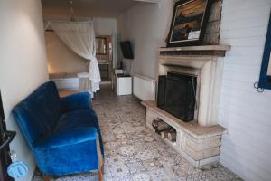 a living room with a blue couch and a fireplace at Park Mandalin Hotel - Adult only in Ağva