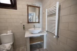 a bathroom with a sink and a toilet and a mirror at Park Mandalin Hotel - Adult only in Ağva