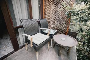 two chairs and a table on a porch at Park Mandalin Hotel - Adult only in Ağva