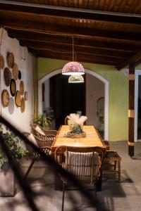 a wooden table and chairs on a patio at Epohikon Studios in Sarti
