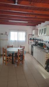 a kitchen with a table and chairs in a room at Costa Edison in Mar del Plata