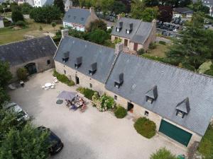 an aerial view of a building with a group of people at Belle villa en bord de mer à 700 m d'une plage de sable fin in Combrit