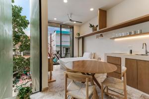 a kitchen and dining room with a table and chairs at Florita 39 Boutique Hotel Breakfast & Beach Club Included in Isla Mujeres