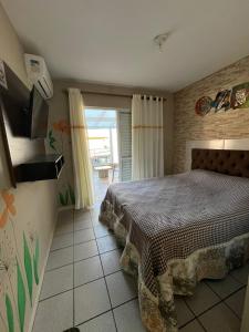 Ένα ή περισσότερα κρεβάτια σε δωμάτιο στο Pousada Residencial da Praia
