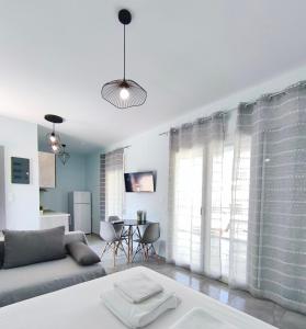 a living room with a couch and a table at Beachway luxury studio C in Nea Peramos