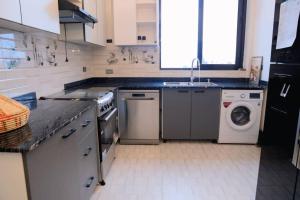 a kitchen with a washing machine and a dishwasher at Kaffuhsmartt in Addis Ababa +16 photos