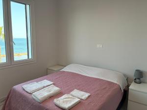 a bedroom with a bed with two towels on it at Miramare in Crotone
