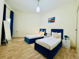 a bedroom with two beds and a dresser at VIP Residence - Exclusively for Ladies in Dubai