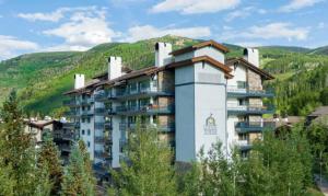 a large apartment building with a mountain in the background at Lodge Tower 281 in Vail