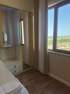 a bedroom with a bed and a large window at Boulevard Sumgait in Sumqayyt