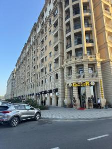 a car parked in front of a large building at Boulevard Sumgait in Sumqayyt