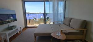 a living room with a couch and a table at Incroyable Vue mer et Notre Dame in Marseille