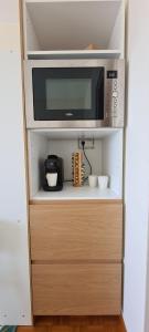 a microwave oven sitting on top of a cabinet at Incroyable Vue mer et Notre Dame in Marseille