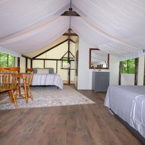a bedroom with a bed and a table and chairs at Growing Faith Farms & Retreat in Moravian Falls