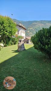 a house in a field with a sign in the grass at Da Lina in Aosta