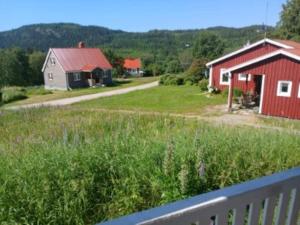 a view of a farm with a red barn at 12 person holiday home in Lidsjöberg in Nedre Lillviken