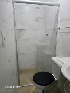 a bathroom with a shower with a toilet and a sink at Casa charmosa em Marituba in Marituba +4 photos