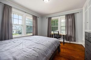 a bedroom with a bed and a desk and windows at 1515 Callender, unit 2 in Peoria