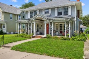 a gray house with a red door at Comfortable Private Room | Shared Bath & Kitchen in Peoria