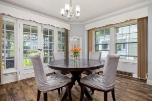 a dining room with a table and chairs and windows at Comfortable Private Room | Shared Bath & Kitchen in Peoria