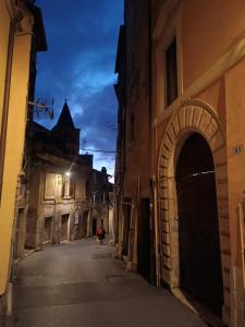 a person riding a scooter down an alley at night at Casa nel quartiere medioevale di Tivoli in Tivoli