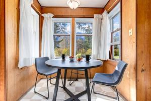 a table and chairs in a room with a window at Huckleberry Lodge Mountain Getaway Near Banff in Canmore