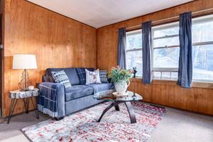 a living room with a couch and a table at Huckleberry Lodge Mountain Getaway Near Banff in Canmore