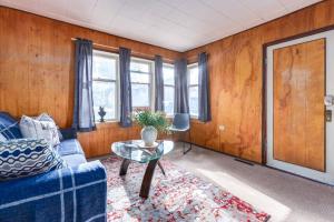a living room with a blue couch and a table at Huckleberry Lodge Mountain Getaway Near Banff in Canmore