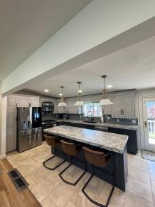 a large kitchen with a large island in the middle at Skiing, 2 Kitchens, 2 Units in 1, 80in TVs, WD, 2 Backyards in Salt Lake City