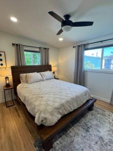 a bedroom with a bed with a ceiling fan at Skiing, 2 Kitchens, 2 Units in 1, 80in TVs, WD, 2 Backyards in Salt Lake City +27 photos