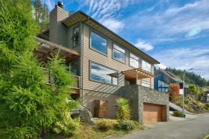 a house on a hill with a mountain at Lakeview Lodge Two with Stunning Views in Queenstown
