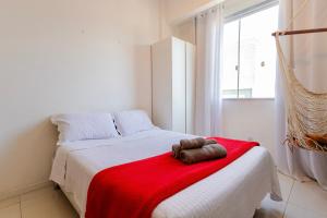 a bedroom with a bed with a red blanket at 360 Botafogo Belair By SUHCasa in Rio de Janeiro