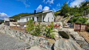 a house on top of a rock wall at Chalet with amazing fjord view in Lingåsen in Valldal