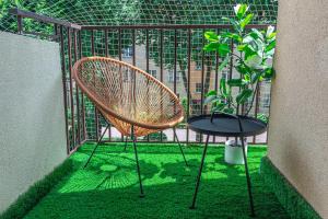 a chair and a table with a potted plant at Apartament HoliStay in Oświęcim