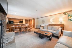 a living room with a couch and a table at Lodge Tower 299 One Bedroom Residence in Vail