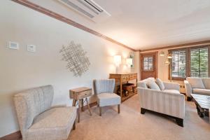 a living room with chairs and a table at Lodge Tower 299 One Bedroom Residence in Vail