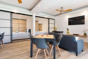 a living room with a couch and a table and chairs at TERA ORA TORU - Lodge and sea view in Papeete