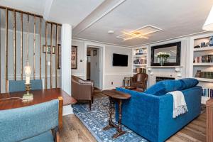 a living room with a blue couch and a table at New England Scholar style retreat in Providence! in Providence