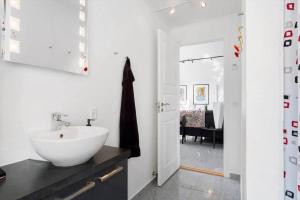 a bathroom with a white sink and a black counter at 496-Snedsted-Niels-Juels-Vej-33 in Snedsted +14 photos