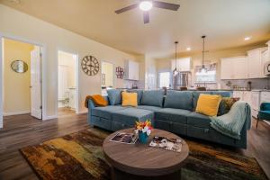 a living room with a blue couch and a table at Family-Friendly 3BR w Hot Tub Games in Charlotte