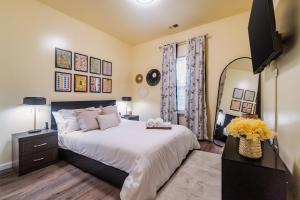 a bedroom with a large bed and a television at Family-Friendly 3BR w Hot Tub Games in Charlotte