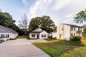 a row of houses with a driveway at Family-Friendly 3BR w Hot Tub Games in Charlotte