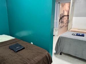 une chambre avec un lit et un mur bleu dans l'établissement Pousada Açude Velho II, à Campina Grande 12 autres photos