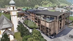 eine Luftansicht eines Gebäudes mit einem Turm in der Unterkunft Hotel Kirchenwirt in Kaunertal