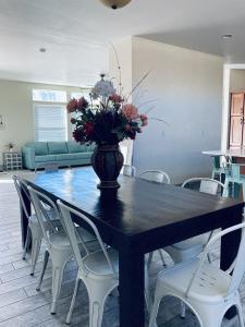 a dining room table with a vase of flowers on it at ️Full Kitchen11 bedbath in this home at discountnear canyonsBoat Parking in Page