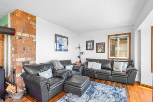 a living room with a couch and a brick wall at Seascape in Oceanside in Oceanside