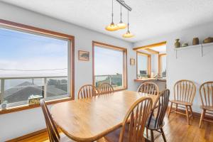 a dining room with a wooden table and chairs at Seascape in Oceanside in Oceanside