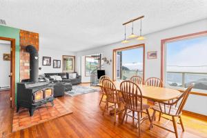 a living room with a table and chairs and a fireplace at Seascape in Oceanside in Oceanside