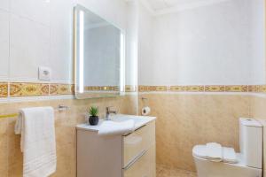 a bathroom with a sink and a toilet and a mirror at Dream Costa Blanca Luxury Apartment in Torrevieja +22 photos