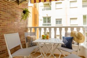 a white table and chairs on a balcony at Dream Costa Blanca Luxury Apartment in Torrevieja